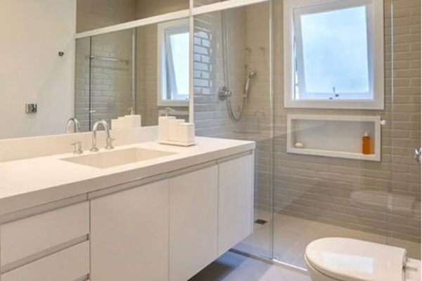 A contemporary bathroom featuring white cabinets and a toilet.